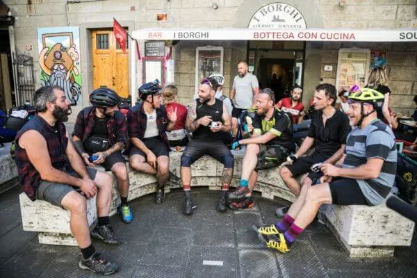 A group of riders sitting outside a bar
