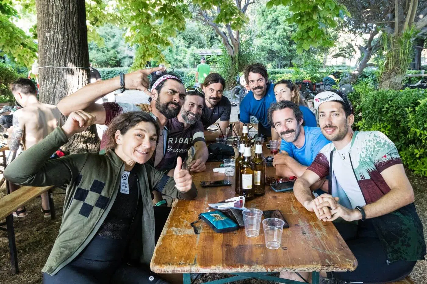 A group of riders toasting at the table