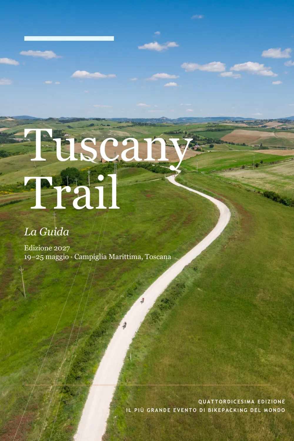 La copertina della guida del Tuscany Trail 2027, una strada bianca fra le colline vista dall'alto