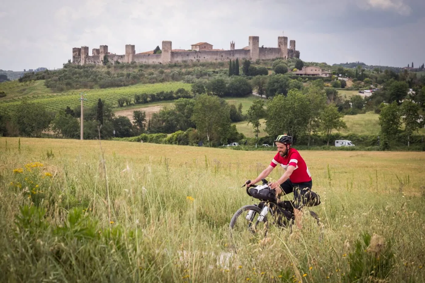 A rider in the fields below the walls of Monteriggioni
