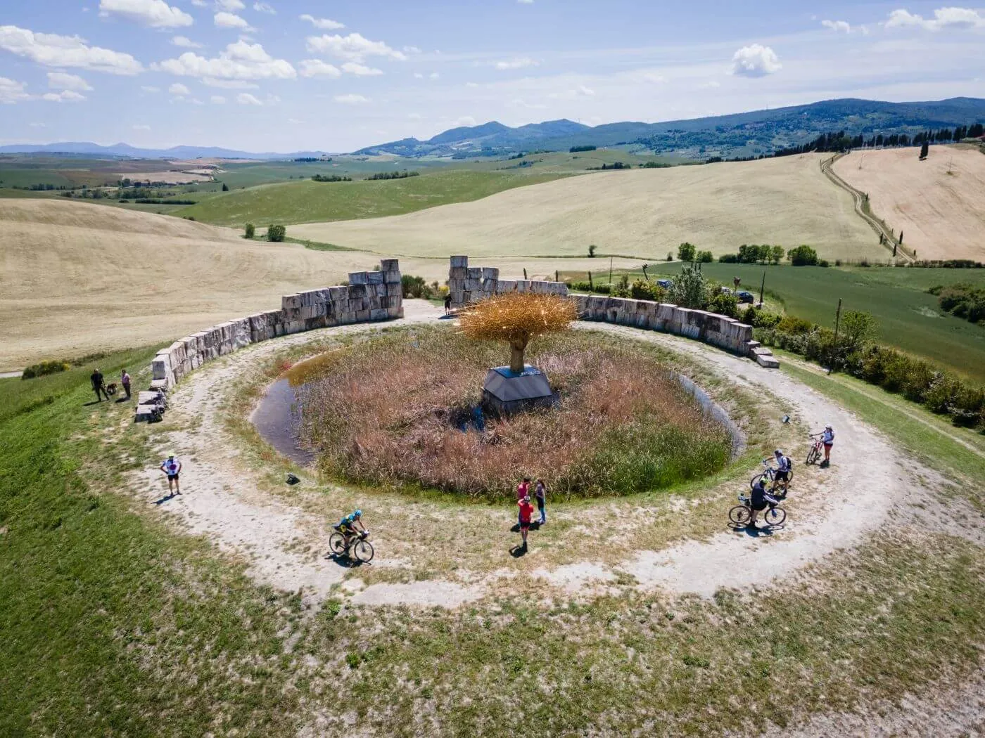 Riders around a circular installation in the fields, seen from above